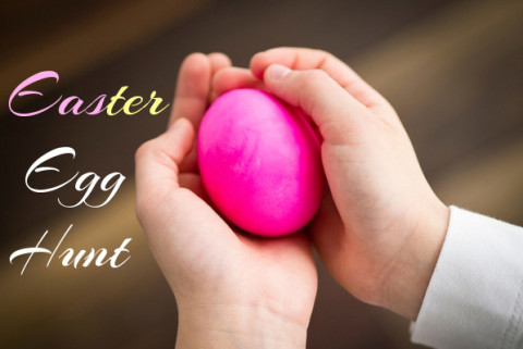 A child's hands holding a pink egg with the words 
